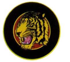Gb. 76 a : Logo Brigade Harimau PDU/PDH Gb. 76 b : Logo Brigade Harimau PDL 1. Bentuk bulat, dengan gambar kepala harimau, warna kuning belang hitam dan lidah merah. 2.